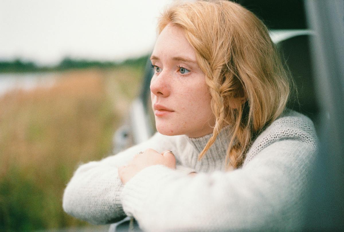 Woman looking out car window